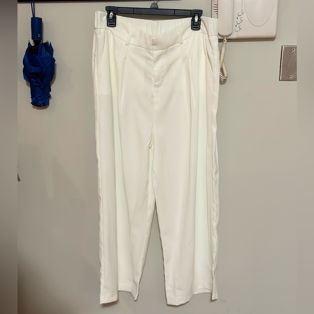 Set of White and Black pleated trousers.